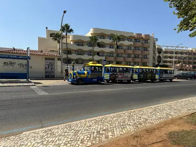 a row of buses parked on the side of a street at Bellavista Modern Comfort, 3 Balcony, Family Apartment with Wi-Fi in Albufeira