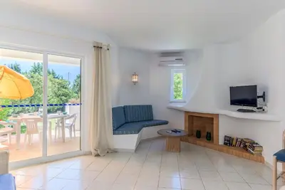 a living room with a couch and a television at FLH Balaia Village Apartment with Pool II in Olhos de Água