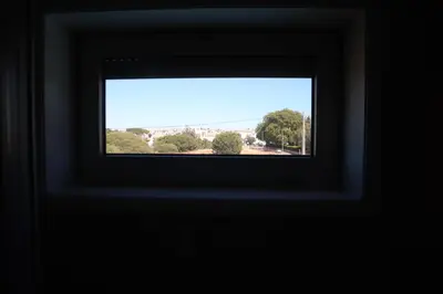 a window in a room with a view of a city at Villa dos Salgados - Beachfront, 6 Golf Courses, 6BDR in Guia
