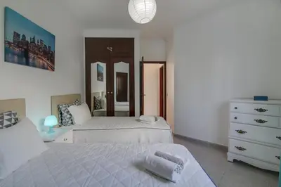 a bedroom with two beds and a dresser at Villa Santo Estevão in Olhos de Água