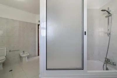 a bathroom with a shower and a toilet at Villa Santo Estevão in Olhos de Água