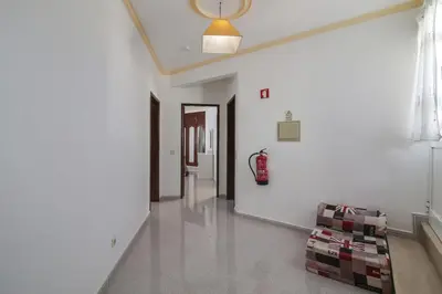 a living room with a couch and a hallway at Villa Santo Estevão in Olhos de Água