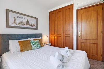 a bedroom with a bed with two towels on it at Villa Paradise in Olhos de Água