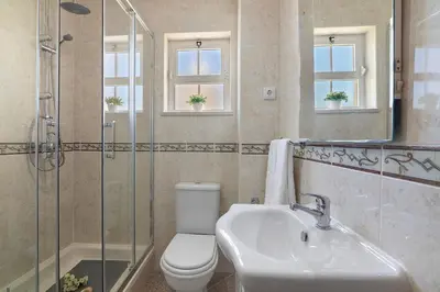 a bathroom with a sink and a toilet and a shower at Villa Paradise in Olhos de Água