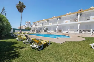 a bedroom with a large bed with towels on it at Villa Paradise in Olhos de Água
