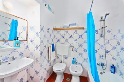a swimming pool with chairs and a house at Villa Simão in Quinta da Balaia in Albufeira