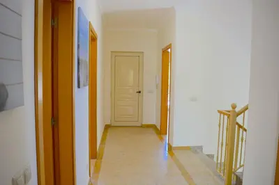 a hallway with a white door and a tile floor at VILA CRISTINA MAR (8 guests and oceanview) in Albufeira