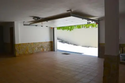 an empty room with a large window and a tile floor at VILA CRISTINA MAR (8 guests and oceanview) in Albufeira