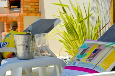a bottle of wine sitting on a table next to a chair at VILA CRISTINA MAR (8 guests and oceanview) in Albufeira