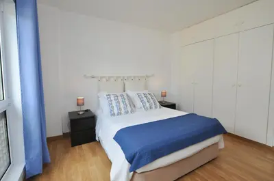 a bedroom with a large bed and two night stands at Tenis Golf Mar by OCvillas in Quarteira