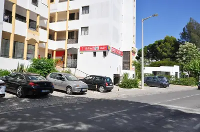 a group of cars parked in front of a building at Tenis Golf Mar by OCvillas in Quarteira