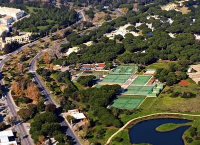 an overhead view of a group of green tennis courts at Tenis Golf Mar by OCvillas in Quarteira