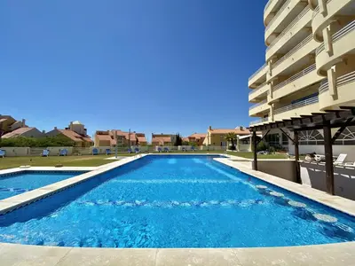 a swimming pool in front of a building at Marina Mar - Near the beach - Vilamoura in Vilamoura