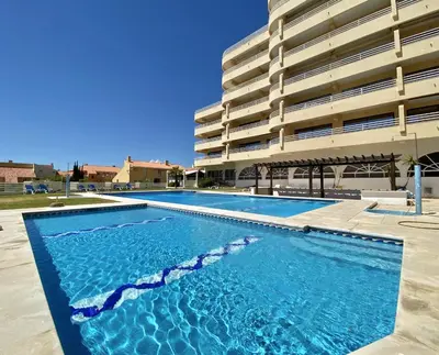 a swimming pool in front of a building at Marina Mar - Near the beach - Vilamoura in Vilamoura