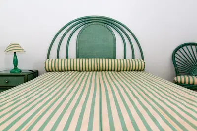 a bedroom with a bed with a striped bedspread at TAC - Vilamoura Center in Vilamoura