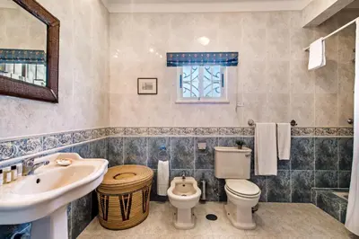 a bathroom with a sink and a toilet at Villa Hideaway by Algarve Villa Holidays in Galé