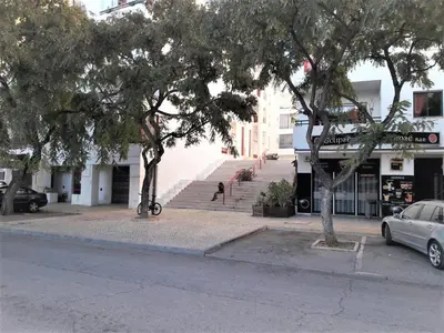 a building with trees on the side of a street at Varandas do Mar 3- Remodelado, Wifi, 150mt Praia in Quarteira