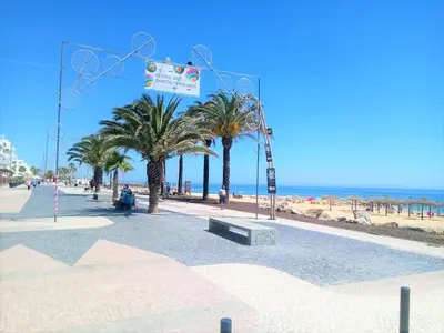 a street with palm trees and the beach at Varandas do Mar 3- Remodelado, Wifi, 150mt Praia in Quarteira