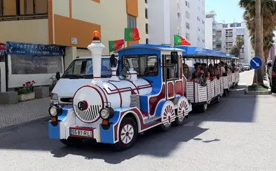 a small train with people riding on it at Varandas do Mar 3- Remodelado, Wifi, 150mt Praia in Quarteira