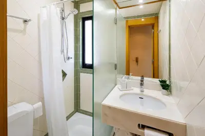 a bathroom with a sink and a shower and a toilet at Victory Village T1 & Rooftop terrace in Quinta do Lago