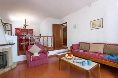 a dining room with a red table and chairs at Villa EP in Albufeira