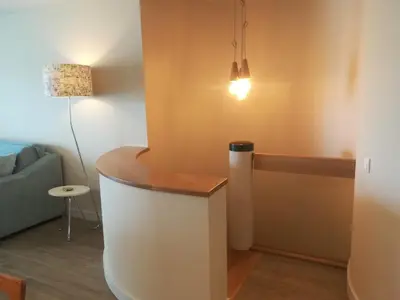 a living room with a couch and a lamp at Victory Village 16F in Quinta do Lago