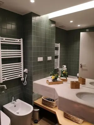 a bathroom with a sink and a toilet and a mirror at Victory Village 16F in Quinta do Lago
