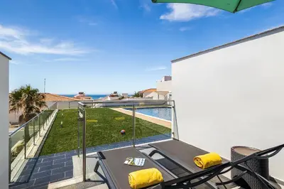 a patio with a table and chairs on a balcony at Praia Mar by OCvillas in Albufeira