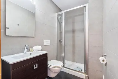 a bathroom with a shower and a toilet and a sink at Praia Mar by OCvillas in Albufeira