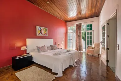 a bedroom with red walls and a bed in a room at Forte São João Villas da Praia in Albufeira