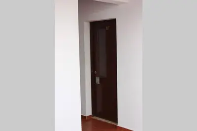 a hallway with a black door in a room at A dois passos da praia in Albufeira