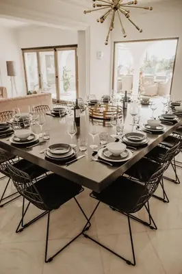 a large table with chairs and a large table with glasses at Granvila in Quarteira