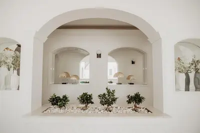 a room with two arches and three plants at Granvila in Quarteira