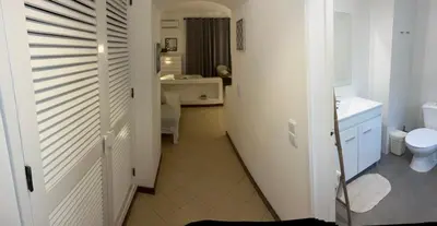 a kitchen with a table and stools in a room at Studio Albufeira in Albufeira