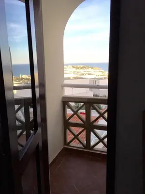 an open door to a balcony with a view of the ocean at Studio Albufeira in Albufeira
