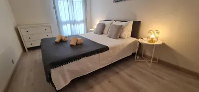 a bedroom with a bed with two stuffed animals on it at Lusitania T2 Frente Mar em Quarteira in Quarteira
