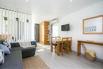 a living room with a couch and a table at Bay View by OCvillas in Albufeira