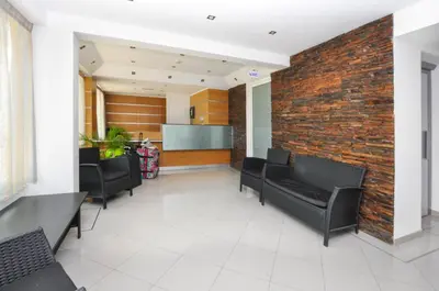 a waiting room with black chairs and a brick wall at Bay View by OCvillas in Albufeira