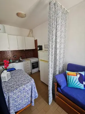 a kitchen with a table and a couch in a room at Vila Planalto - Golfe - Entre o Golfe e o Mar in Vilamoura
