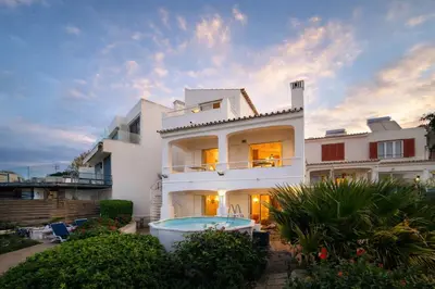 a white house with a swimming pool in front of it at Beira Mar by Check-in Portugal in Albufeira