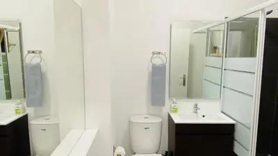 a bathroom with a toilet and a sink and a mirror at Rooftop by Check-in Portugal in Albufeira