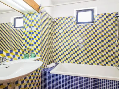 a bathroom with yellow and blue checkered walls at Villa Villa Jacaranda V3 by Interhome in Albufeira