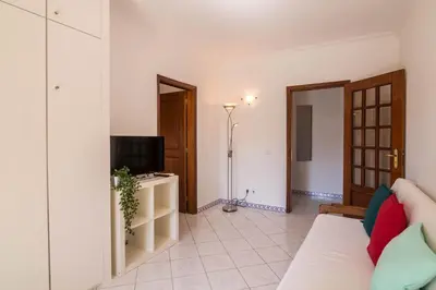 a living room with a couch and a television at Marjoh Al in Quarteira