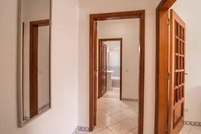 a hallway with two mirrors on the wall at Marjoh Al in Quarteira