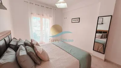 a bedroom with a bed and a mirror at Kamaleon Sol by Sunny Deluxe in Albufeira