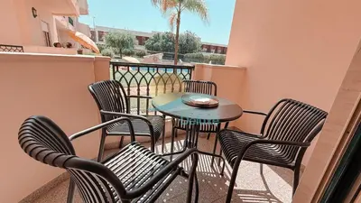 a group of chairs and a table on a balcony at Kamaleon Sol by Sunny Deluxe in Albufeira