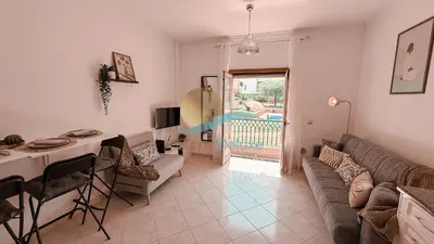 a living room with a couch and a table at Kamaleon Sol by Sunny Deluxe in Albufeira
