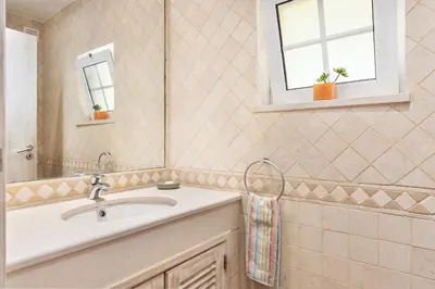 a bathroom with a sink and a mirror at Villa Dome by OCvillas in Albufeira