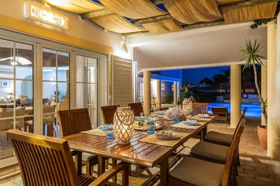 a dining room with a wooden table and chairs at Villa Dome by OCvillas in Albufeira