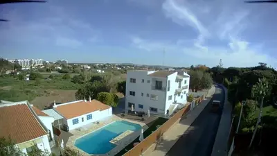 a villa with a swimming pool and a house at Hospedaria do Almargem in Quarteira